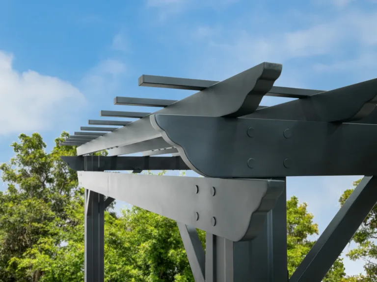 Close-up of dark pergola beams, rafters, seams, and bolted connection details