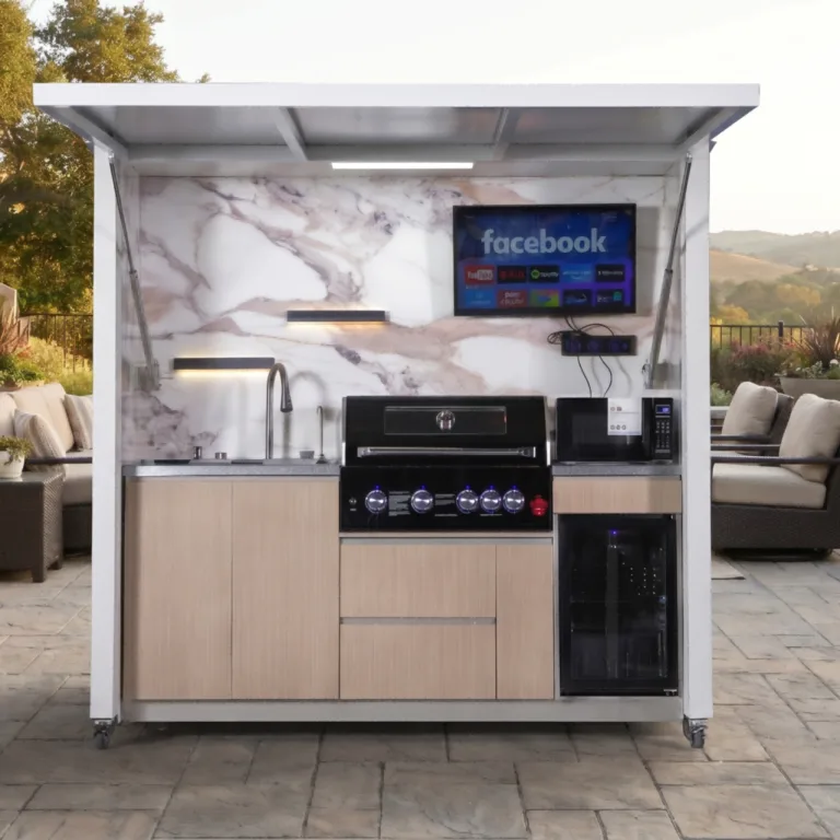 White outdoor kitchen with illuminated work surface grill sink refrigerator and overhead canopy