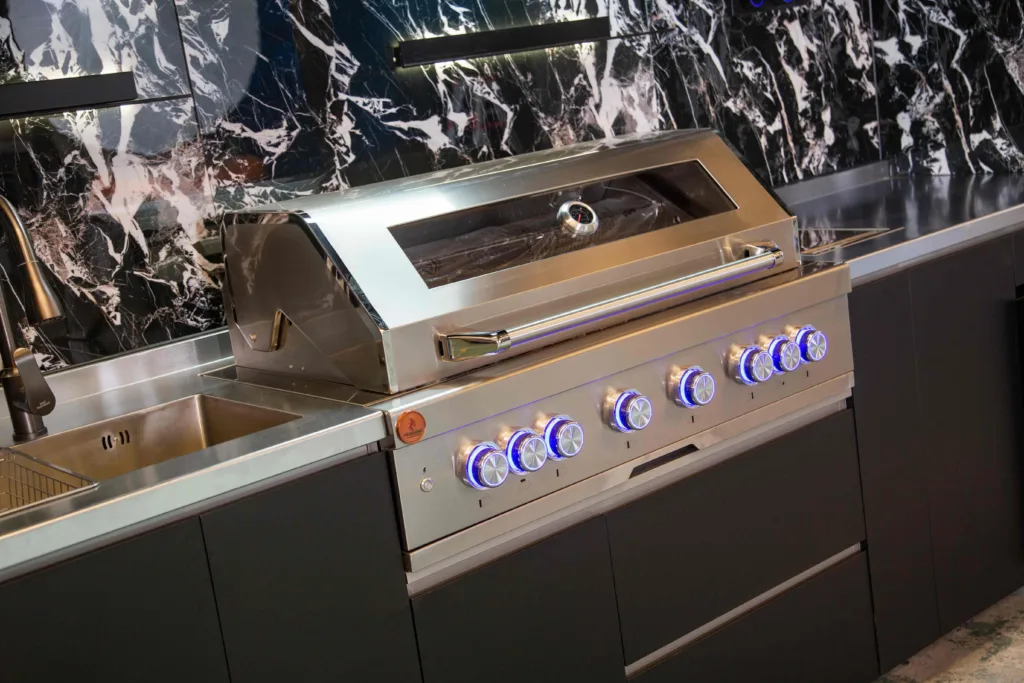Built-in outdoor kitchen with grill storage and weather-resistant cabinets