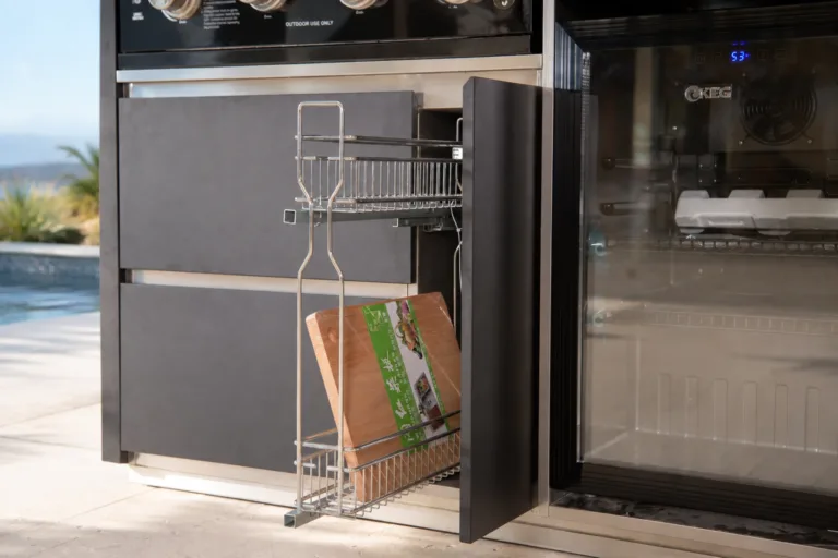 Easy-reach outdoor kitchen pull-out beside a refrigerator on a coastal terrace