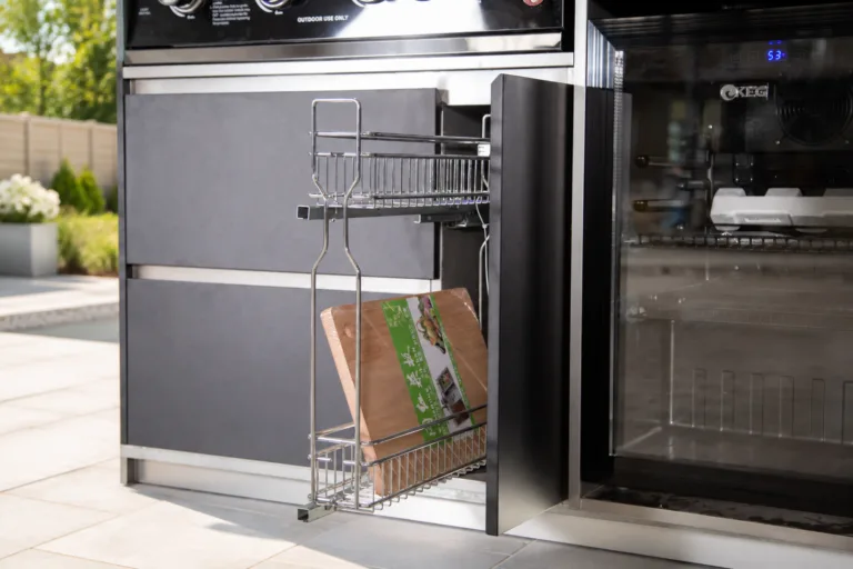 Outdoor kitchen pull-out storage in a bright family backyard patio