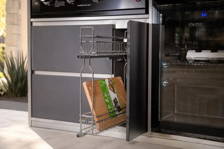 Luxury outdoor kitchen cabinetry and refrigeration in a landscaped Austin patio setting