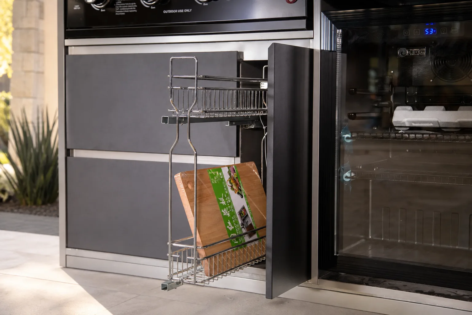 Luxury outdoor kitchen cabinetry and refrigeration in a landscaped Austin patio setting